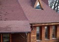 Roof Asphalt Shingles and Attic Mansard Window. Roofing Construction. Roofing Repair. Rain gutter Royalty Free Stock Photo