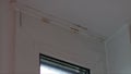 Roof or balcony is leaking due to heavy rain, drops slowly fall down. Close-up. Concept of emergency condition of housing,