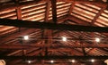 The roof with beams facing bricks and halogen lamps Royalty Free Stock Photo