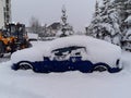 Roof and blue car covered with snow on outdoors parking in winter day Royalty Free Stock Photo