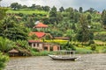 Roof boat anchored at the coast with rwandan village in the background, Kivu lake, Rwanda Royalty Free Stock Photo