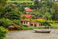 Roof boat anchored at the coast with rwandan village in the background, Kivu lake, Rwanda Royalty Free Stock Photo