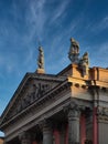 Roof of a building with figures and blue sky