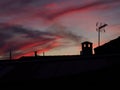 Roof of the building in shadow during scenic pink sunset in the evening Royalty Free Stock Photo