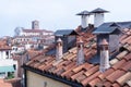 Roof with chimneys with blurred view over Venice in the early morning, Italy Royalty Free Stock Photo