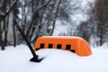 Roof of city taxi and orange symbol covered with snow. Snowfall, heavy precipitation and snow drifts paralyze traffic Royalty Free Stock Photo