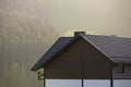 Roof of cottage with siding walls, brown shingle roof and high c Royalty Free Stock Photo