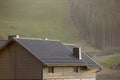 Roof of cottage with siding walls, brown shingle roof and high c Royalty Free Stock Photo