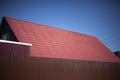 Roof of a country house. The tiles are red. Fence and roof Royalty Free Stock Photo