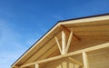 Roof design of wooden terrace house, textured surface and supporting beams, against blue sky Royalty Free Stock Photo