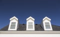 Roof Dormers and Windows Against Deep Blue Sky