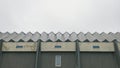 roof and facade of the building against the gray sky