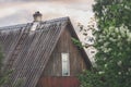 Roof and facade with a window of an old wooden country house Royalty Free Stock Photo