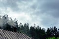 The roof of a forest house with smoke Royalty Free Stock Photo