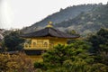 Roof of the Golden pavilion in bushy forest in Kyoto, Japan