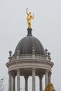 Roof golden statue of ancient beautiful woman with a heart in flame and laurel branch in her hands in historical downtown of