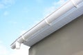 Roof gutter repair. Rain gutter installation with drain downspout pipe. Guttering with soffits Royalty Free Stock Photo