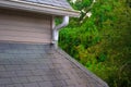 Roof gutter and runoff pipe on a rainy day Royalty Free Stock Photo