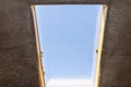 Roof hatch located in the attic for chimney sweep service, simple wooden frame with window. Royalty Free Stock Photo