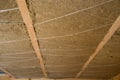 Roof heat isolation with mineral wool in wooden house, building under construction Royalty Free Stock Photo