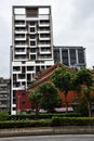 Roof of a historic temple in front of a modern block building, a culture clash in Taipei, Taiwan