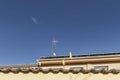 Roof of a house with an anemometer, a weather vane and some television antennas Royalty Free Stock Photo