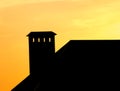 Roof of a house with a chimney at sunset Royalty Free Stock Photo