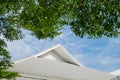 Roof of the house with green tree, blue sky and cloud in vintage Royalty Free Stock Photo