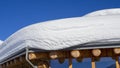 The roof of an house or hotel covered by massive quantity of fresh snow after heavy snowfall