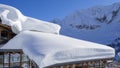 The roof of an house or hotel covered by massive quantity of fresh snow after heavy snowfall