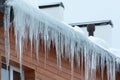 Roof of the house with snow and icicles