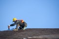 Roof installer Are installing the roof of the house that is Ceramic tile roof at construction site Royalty Free Stock Photo