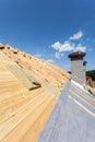 Roof insulation. New wooden house under construction with chimneys against blue sky Royalty Free Stock Photo