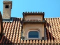 Roof of a medieval house with dormer roof tiles and fireplace with brick cover Royalty Free Stock Photo