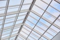 Roof of modern builduing. Glass ceiling photographed from inside. Shopping center. Vintage contemporary architecture. Toned image.