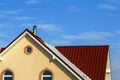 Roof of a new built house with nice window and chimney. Royalty Free Stock Photo