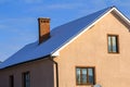 Roof of a new built house with nice window and chimney. Royalty Free Stock Photo