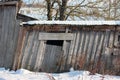 The roof of an old abandoned house in the village in winter. Snowy and Sunny day. Empty house, without people, dilapidated, broken Royalty Free Stock Photo