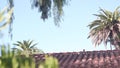 Roof of old mexican house tiled, ceramic clay tiles. Suburban California garden.