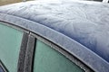 The roof of a passenger car froze with heavy flower-shaped icing. Police may fine for poorly cleaned car. there must be no snow or Royalty Free Stock Photo