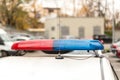 Roof of a police patrol car with flashing blue and red lights, sirens and antennas Royalty Free Stock Photo