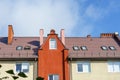 Roof of a residential building with dormers, attic light. Roofing skylights, the bright facade of a building in Europe