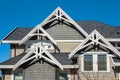 Roof shingles on top of the house against blue sky. Dark asphalt tiles on the roof background. black shingles, roof tile