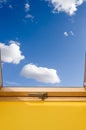 Roof skylight window and bue sky with white clouds