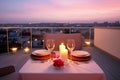 Roof terrace with festive table setting for romantic dinner by candlelight with city view. Decorations for Valentine Royalty Free Stock Photo