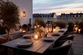 Roof terrace with festive table setting for romantic dinner by candlelight with city view. Decorations for Valentine Royalty Free Stock Photo