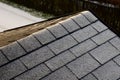 Roof tiles made of plastic imitation wooden shingles. view of rows of gray narrow recycled boards. vents in several elegant bumps.