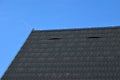 Roof tiles made of plastic imitation wooden shingles. view of rows of gray narrow recycled boards. vents in several elegant bumps.