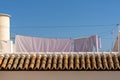 Roof tiles and rooftop porch with bedclothes and laundry hanging out to dry