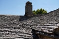 roof tiles stone grey from old house medieval building with chimney gray stones background Royalty Free Stock Photo